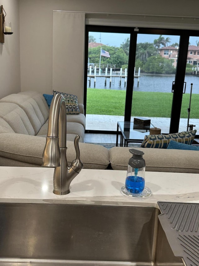 living room with sink and a water view