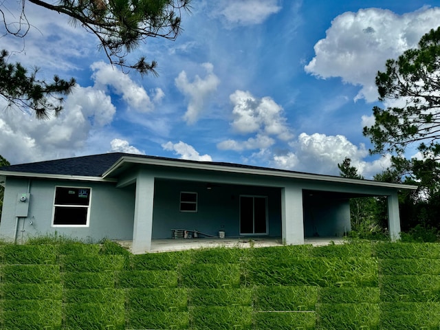 rear view of property with a patio and a yard