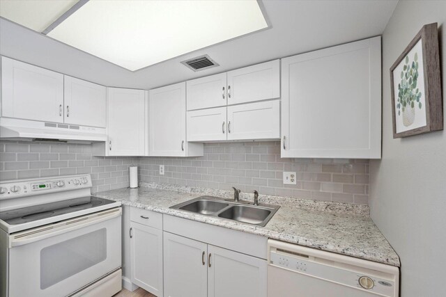 kitchen featuring backsplash, sink, white cabinetry, and white appliances