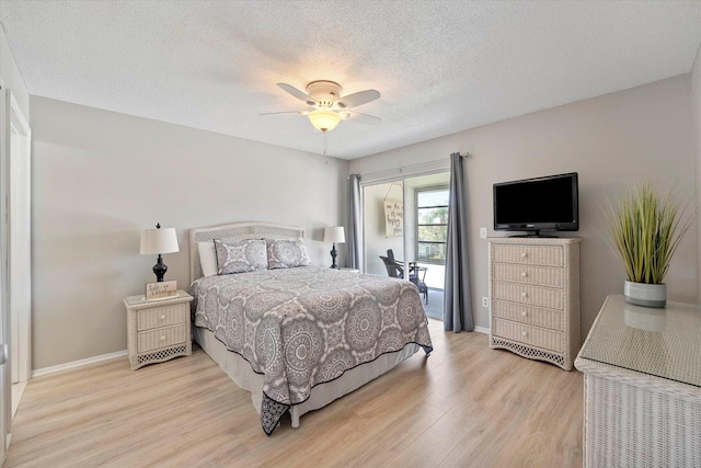 bedroom with a textured ceiling, access to exterior, ceiling fan, and light hardwood / wood-style flooring