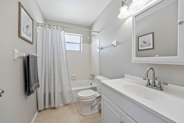 full bathroom featuring tile floors, shower / bath combo, toilet, and vanity with extensive cabinet space