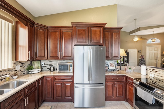 kitchen with decorative backsplash, appliances with stainless steel finishes, vaulted ceiling, ceiling fan, and sink