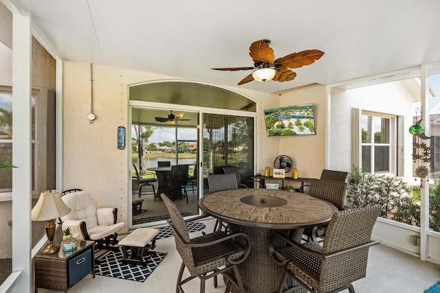 sunroom / solarium featuring ceiling fan