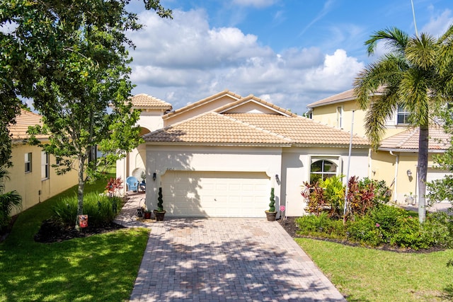 mediterranean / spanish home with a front yard and a garage