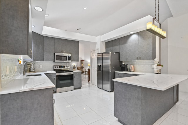 kitchen featuring sink, decorative backsplash, light tile patterned floors, kitchen peninsula, and stainless steel appliances