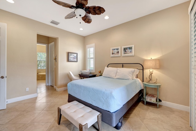 tiled bedroom featuring ceiling fan and ensuite bathroom