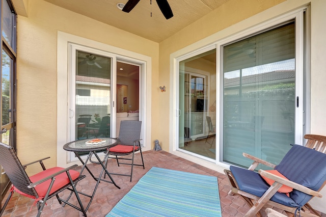 exterior space with ceiling fan and a patio