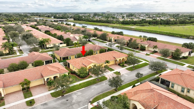 drone / aerial view featuring a water view and a residential view