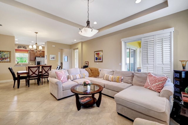 living room featuring light tile patterned floors, a chandelier, recessed lighting, baseboards, and a tray ceiling