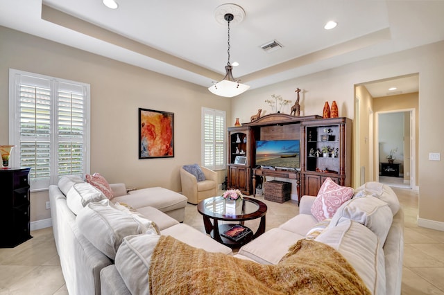 tiled living room with a raised ceiling