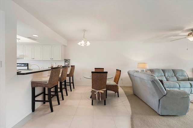 1600 NE Dixie Hwy Unit 10-205, Jensen Beach, FL 34957 - dining room with a chandelier, baseboards, a ceiling fan, light tile patterned flooring, and recessed lighting