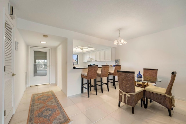 dining space featuring light tile patterned floors and a chandelier