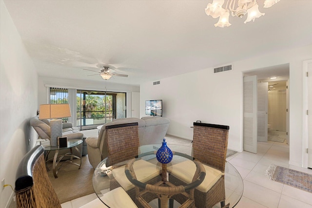1600 NE Dixie Hwy Unit 10-205, Jensen Beach, FL 34957 - dining room with ceiling fan, a chandelier, and light tile patterned floors