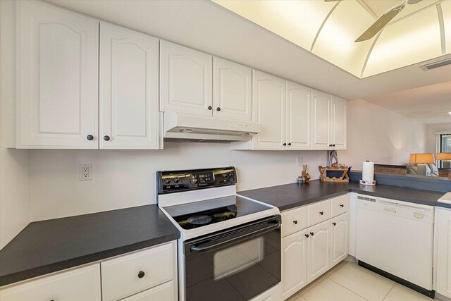 1600 NE Dixie Hwy Unit 10-205, Jensen Beach, FL 34957 - kitchen with white dishwasher, electric range, under cabinet range hood, and dark countertops