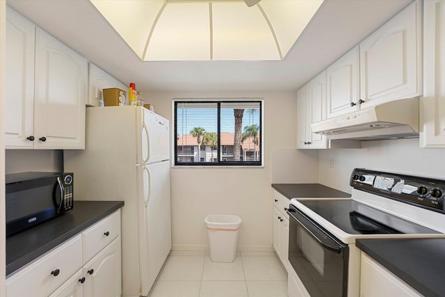 1600 NE Dixie Hwy Unit 10-205, Jensen Beach, FL 34957 - kitchen with electric range oven, under cabinet range hood, black microwave, dark countertops, and white cabinets
