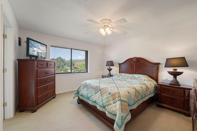 1600 NE Dixie Hwy Unit 10-205, Jensen Beach, FL 34957 - bedroom with light carpet, a ceiling fan, baseboards, and a textured ceiling