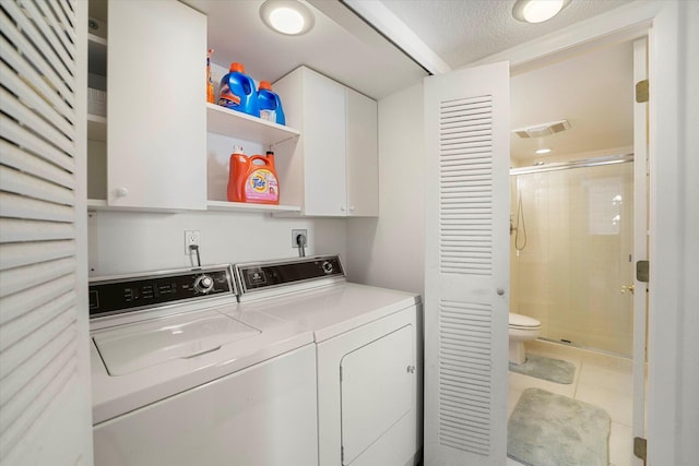 1600 NE Dixie Hwy Unit 10-205, Jensen Beach, FL 34957 - laundry room featuring cabinet space, washing machine and clothes dryer, and tile patterned flooring