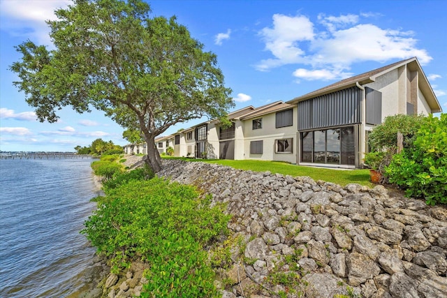 1600 NE Dixie Hwy Unit 10-205, Jensen Beach, FL 34957 - back of property featuring a water view and stucco siding