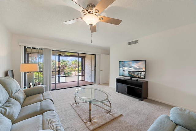 carpeted living room with ceiling fan