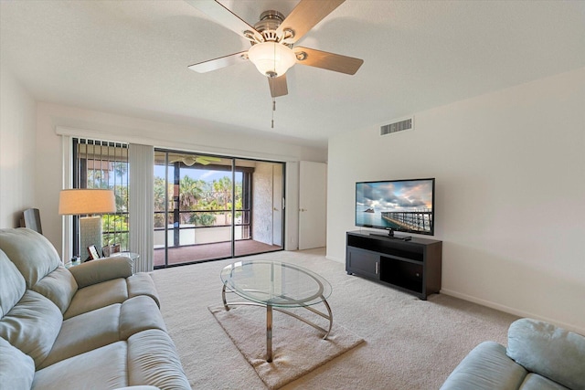 1600 NE Dixie Hwy Unit 10-205, Jensen Beach, FL 34957 - living room with carpet floors, a ceiling fan, and baseboards