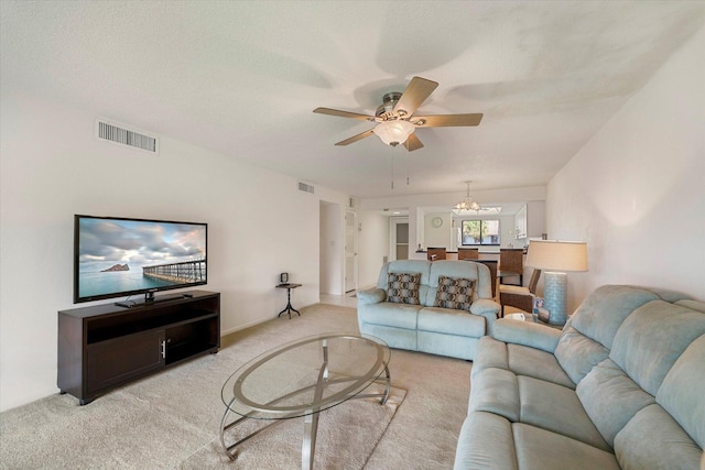 1600 NE Dixie Hwy Unit 10-205, Jensen Beach, FL 34957 - living area featuring light colored carpet, ceiling fan, and a chandelier