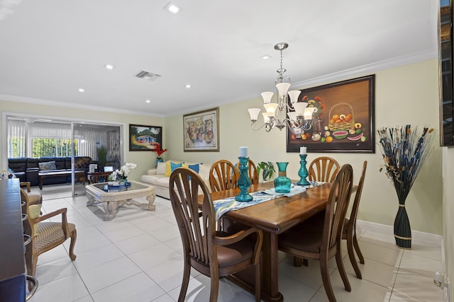 tiled dining space featuring crown molding and a chandelier