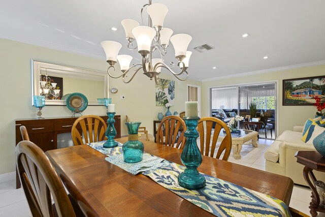 dining space featuring a notable chandelier, light tile patterned floors, and crown molding