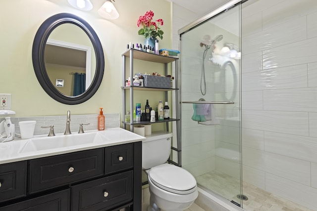 bathroom with backsplash, vanity, an enclosed shower, and toilet