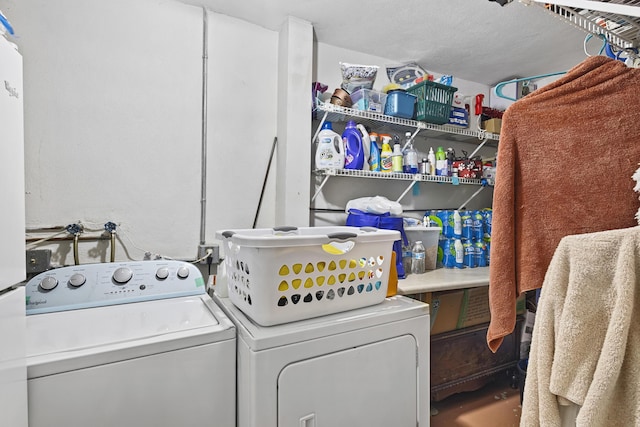 laundry room featuring washing machine and dryer and a textured ceiling