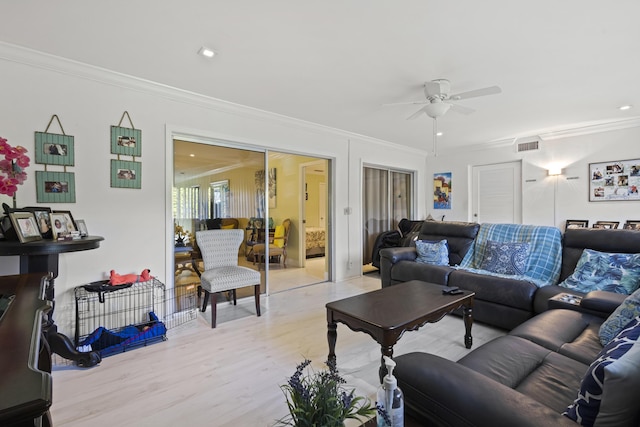 living room featuring ceiling fan, light hardwood / wood-style flooring, and ornamental molding