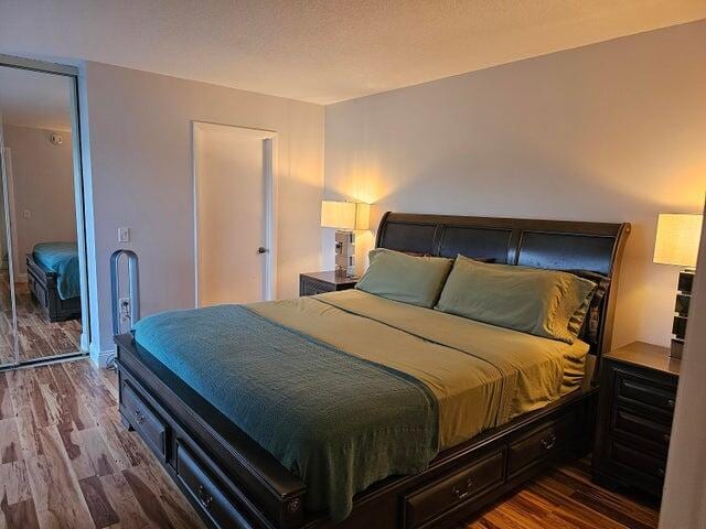 bedroom featuring hardwood / wood-style floors and a textured ceiling