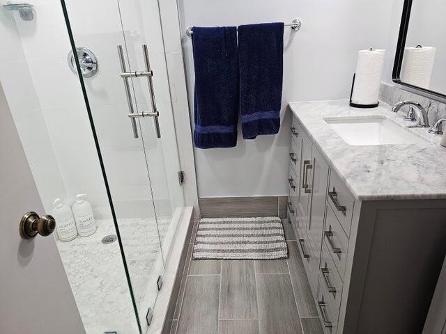 bathroom with vanity and a shower with shower door