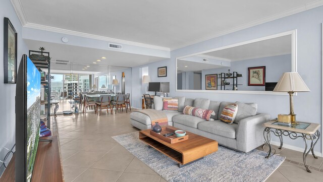 living room featuring ornamental molding and light tile floors