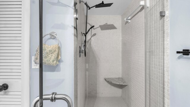 bathroom featuring a shower with shower door