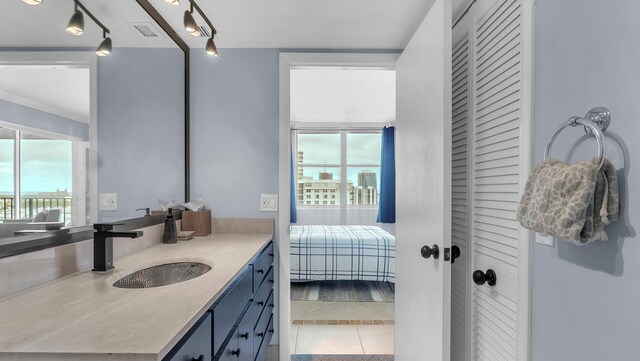 bathroom featuring tile floors, vanity, and rail lighting