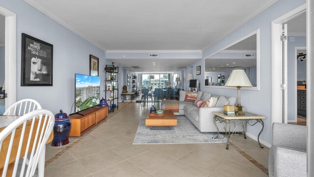 living room with ornamental molding and light tile floors