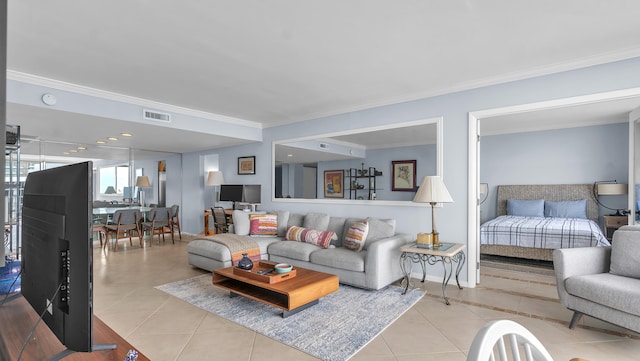 living room featuring ornamental molding and light tile floors