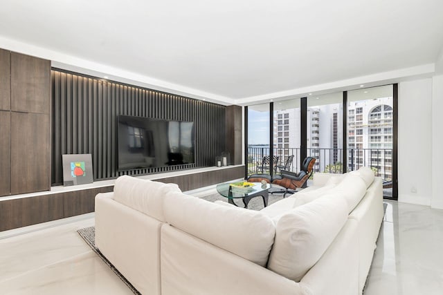 living room with light tile flooring and a wall of windows