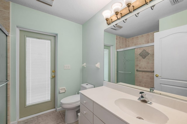 bathroom featuring an enclosed shower, a textured ceiling, vanity, tile patterned flooring, and toilet