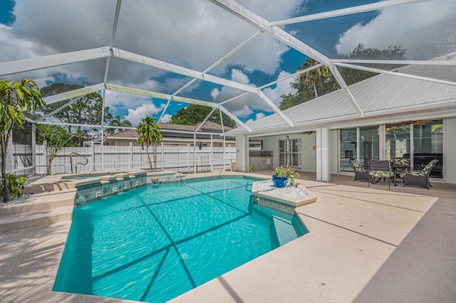 view of pool featuring a patio, ceiling fan, and a lanai