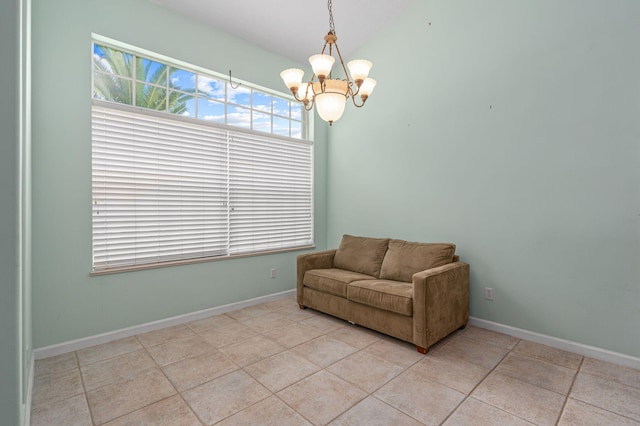 living area with light tile patterned floors and an inviting chandelier