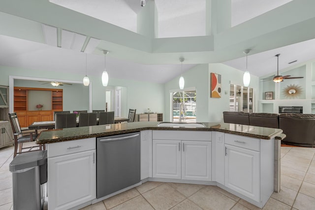 kitchen with white cabinets, sink, stainless steel dishwasher, ceiling fan, and decorative light fixtures