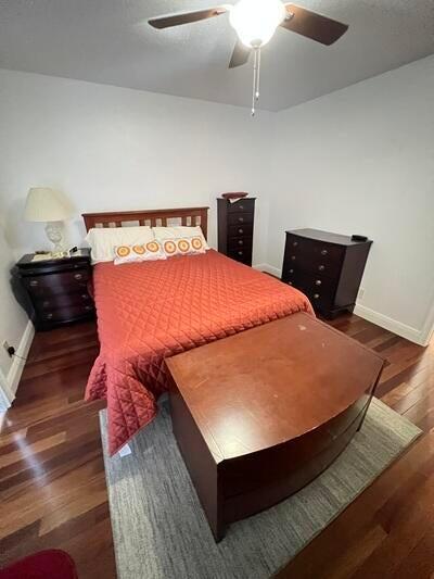 bedroom featuring ceiling fan and dark hardwood / wood-style flooring