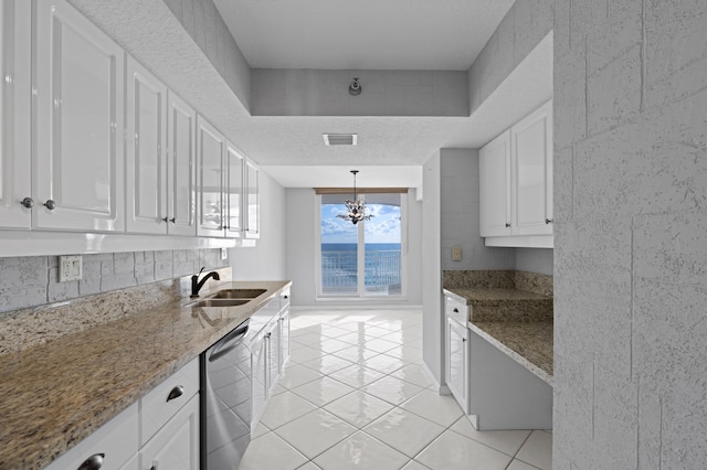 kitchen with dishwasher, sink, pendant lighting, stone countertops, and white cabinets