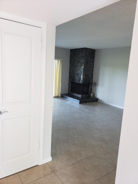 unfurnished living room featuring tile patterned flooring and a fireplace