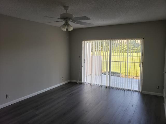 spare room with a textured ceiling, ceiling fan, a healthy amount of sunlight, and dark wood-type flooring