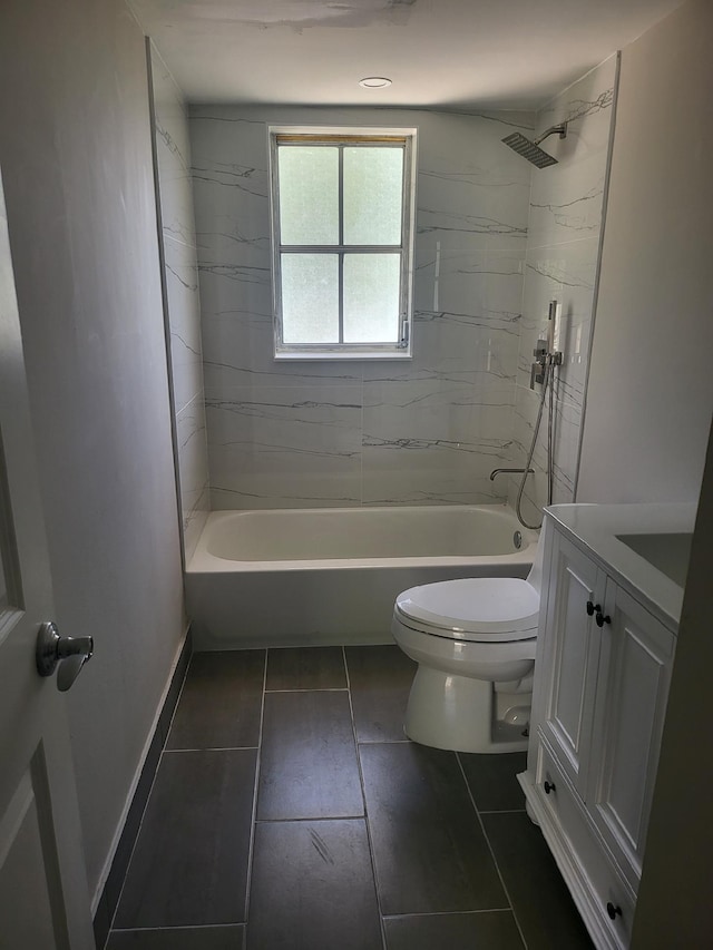 full bathroom featuring tile patterned floors, vanity, toilet, and tiled shower / bath