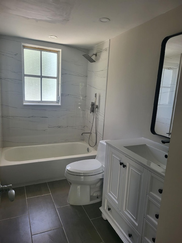 full bathroom with tiled shower / bath, tile patterned floors, vanity, and toilet