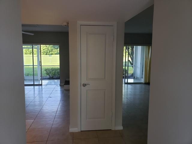 hallway with tile patterned floors