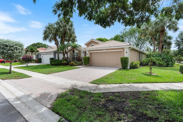 view of front of property featuring a garage and a front yard